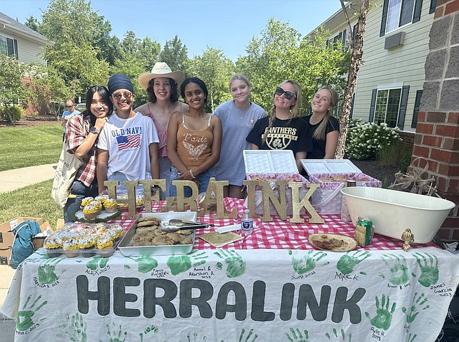 Herralink volunteers helping prepare for a Wild West event with donations from Wegmans, Crumbl, and Cupcake Delivers, and Fantasy Florists.