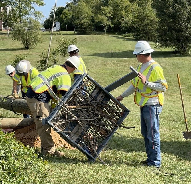 Dave Lawlor and Bill Beletsky attach osprey nest box to donated utility pole