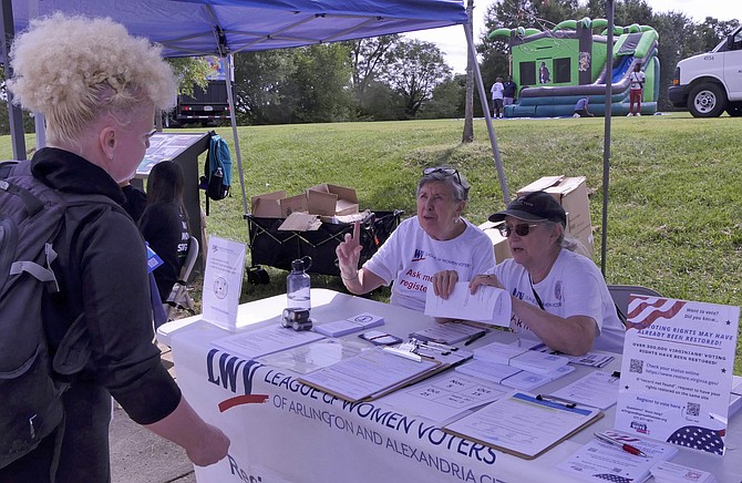 Claudia Scott and Faye Pritchard register voters at the voter registration and information booth at Green Valley Day. Just as important, they answer questions.