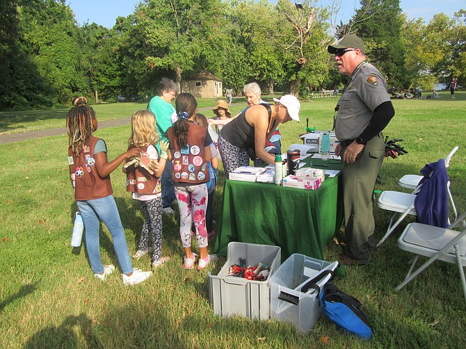 The Brownie and Daisy troops checked in at one of two stations, here with NPS volunteer coordinator, Scott Hill and FODMer Terry Chandler.