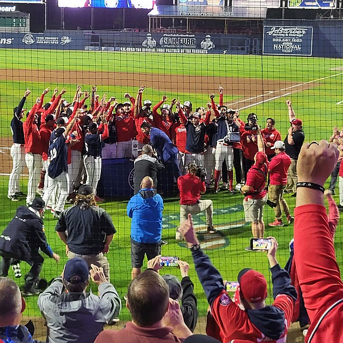 From behind home plate, the victorious FredNats can be seen celebrating their first championship season.