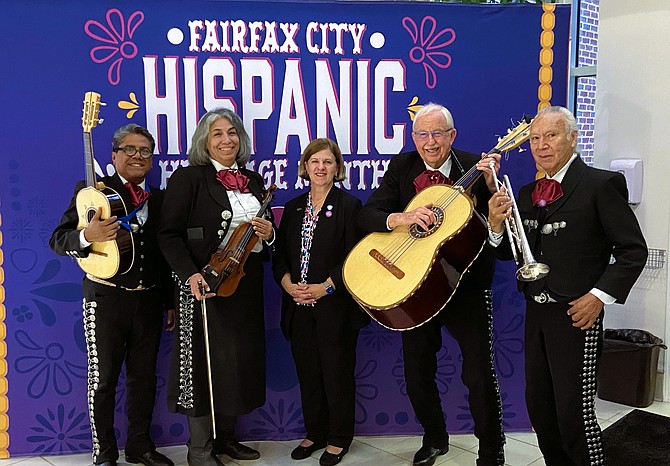 Fairfax Mayor Catherine Read (center) poses with the members of Mariachi Estrellas (from left) Jorge Anaya, Judith Gomez, Daniel Sheehy and Richie Medrano. The group entertained prior to the Sept. 24 City Council meeting, during which Read read a proclamation recognizing National Hispanic Heritage Month in Fairfax City.