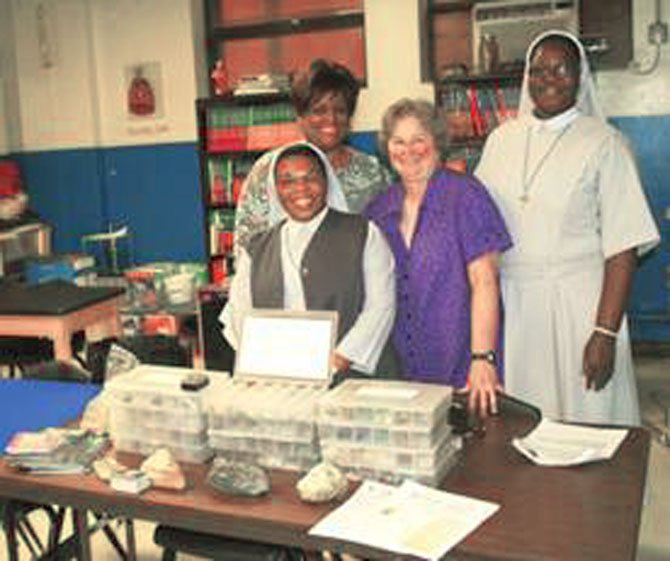 Sister Lucy Dei (right) of St. Augustine Catholic Church with the donated boxes of minerals.