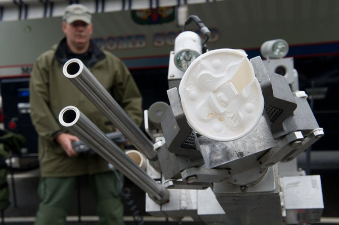 Police officer Tom Eggers of the Fairfax County Police Explosives Ordinance Unit demonstrates the fine control of the unit’s EOD robot by picking up a Styrofoam cup during a demonstration on April 26 in Fairfax. The robot, unofficially known in the Fairfax EOD unit as "Charlotte," is the most common robotic platform used by police departments in the Unite States and has been used by the Fairfax County Police Department since 2002.