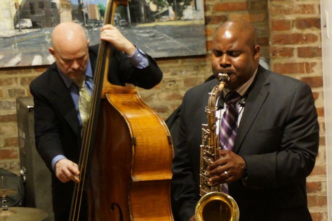 Saxophonist Vaughn Ambrose performs at the Principle Gallery as part of First Night Alexandria.