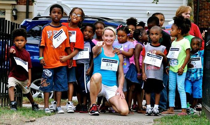 Brooke Curran at a 1K fun run with children taking home new books.