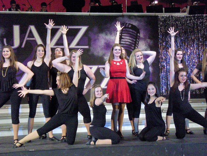 Soloist Amanda Mason (in red) and friends are “Holding Out for a Hero.”
