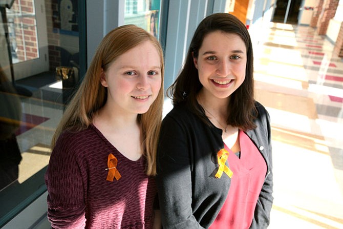 T.C. Williams High School students Hannah Miller (left) and Jay Falk organized a day against gun violence on Tuesday. Their #WeAreAllEagles event was adopted by the school, prompting over 1,000 T.C. students to wear ribbons and the school colors of Marjory Stoneman Douglas High School in Parkland, Fla., which suffered 17 deaths from a shooting on Feb. 14.