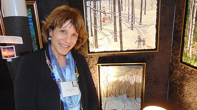 Ronni Jolles with her paintings with layered paper.