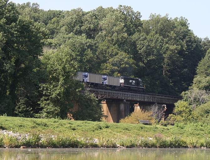 Trains travel at high speeds over the bridge at Lake Accotink.