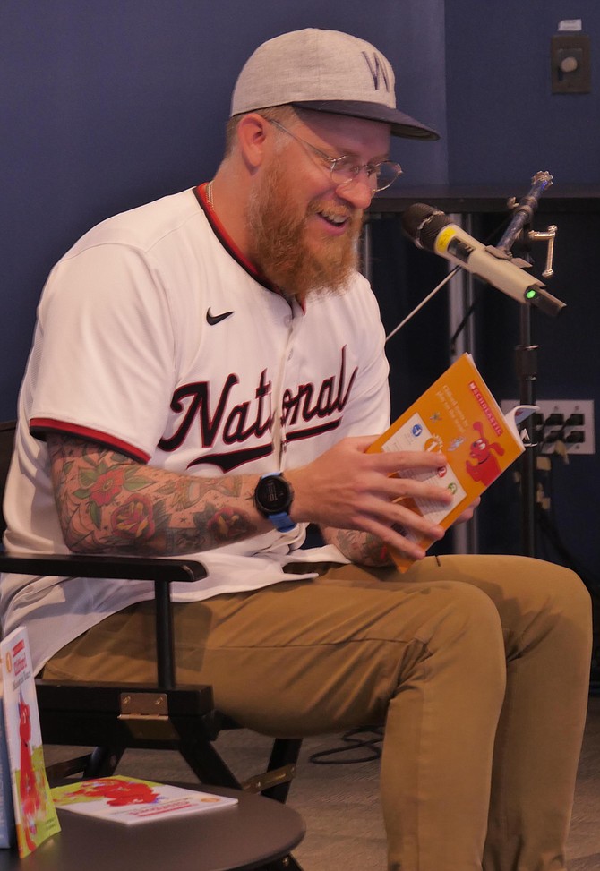 Sean Doolittle, former Nationals player, reads “Clifford Makes the Team” at story hour held Saturday, June 8 at Arlington Central Library.