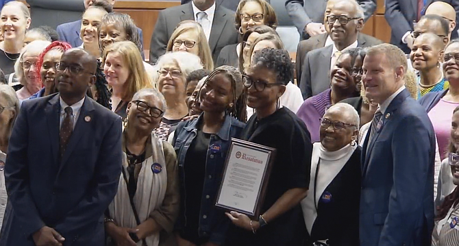 The Fairfax County Supervisors present the county’s former chief equity officer, Karla Bruce, with a resolution to honor and recognize her 25 years of service.