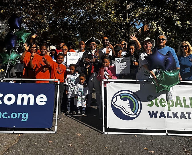 Alexandria’s Town Crier, Ben Fiore-Walker, center, poses for a photo with participants in the StepALIVE! Walk-a-Thon Oct. 20 at First Christian Church.