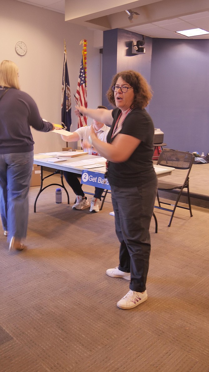 Stephanie Sanders, who is the chief Election official at the Central Library voting site, says “It is crazy here. It has been very busy this morning.”