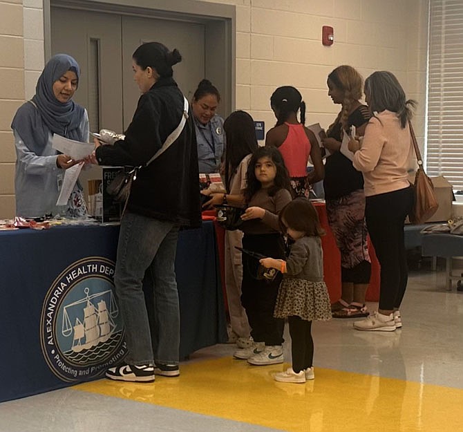 Families receive information on city and nonprofit health programs at Community Resource Day Sept 22 at Patrick Henry Elementary School.