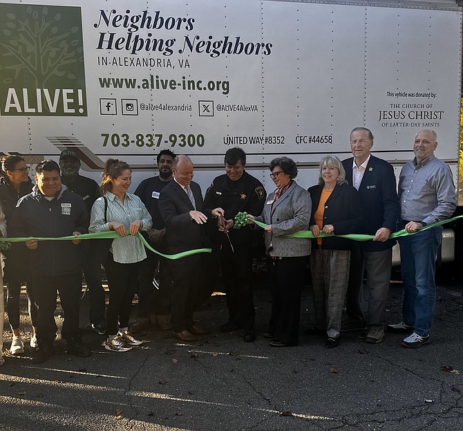 Sheriff Sean Casey, center, cuts the ribbon to the new ALIVE! refrigerated food truck Nov. 12 at the organization’s headquarters in Old Town. The truck was donated by the Church of Jesus Christ of Latter-Day Saints.