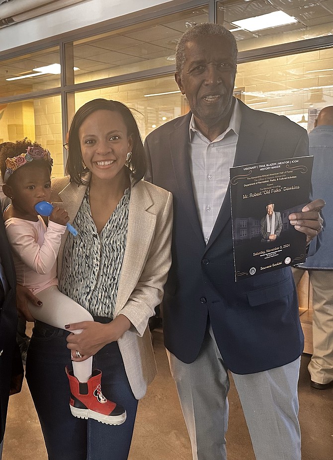 Mayor-elect Alyia Gaskins, left, holding her daughter Eliana, and the Hon. Nolan Dawkins at a reception honoring Dawkins’ late brother Robert Dawkins Nov. 9 at the Charles Houston Recreation Center.