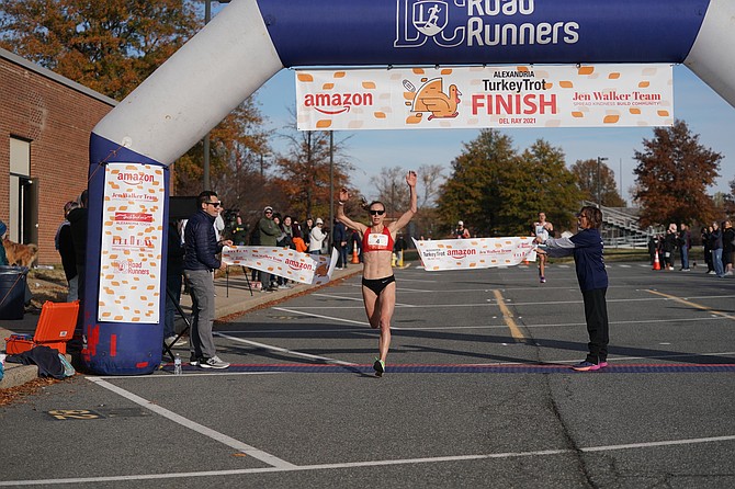 Susanna Sullivan breaks the tape in the 2021 Alexandria Turkey Trot. She will serve as Grand Marshal of the 2024 Turkey Trot Nov. 28 in Del Ray.