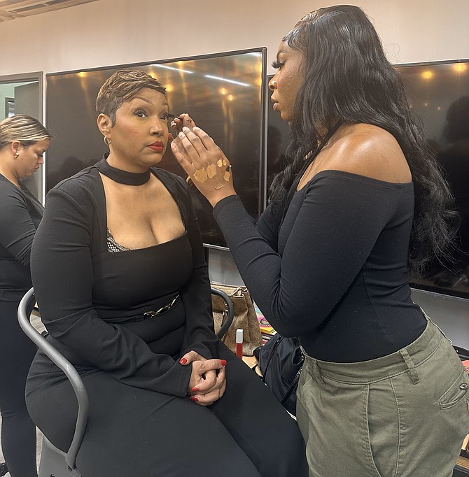 A makeup artist puts the finishing touches on model Angela Harris backstage at the IMperfeKtlymade Foundation fashion show Oct. 19 at The Garden in Alexandria. Harris, who is blind, founded the organization to assist blind and low vision members of the community.