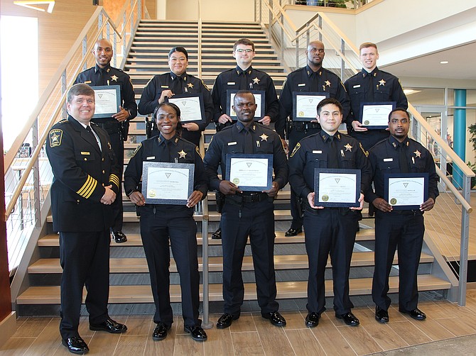 Sheriff Sean Casey, left, poses for a photo with the recent graduate of the Northern Virginia Criminal Justice Training Academy. From l-r in front: Sheriff Sean Casey, Deputy Koroma, Deputy Otieno, Deputy Amaya and Deputy Jones. Back: Deputy Mills, Deputy Vasquez, Deputy Leiberg, Deputy Tyler and Deputy Washington.