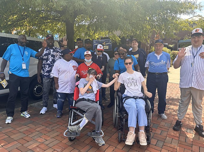 Members of the Miracle League of Alexandria pose for a team photo prior to the Sept. 21 game in honor of first responders.