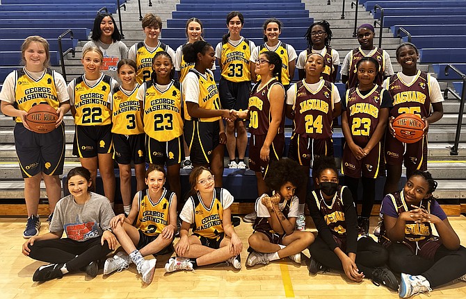 Members of the GWMS and Jefferson-Houston girls basketball teams pose for a photo after the inaugural Middle School Girls Basketball Championship Dec. 3 at ACHS. GWMS won the game 22-14.