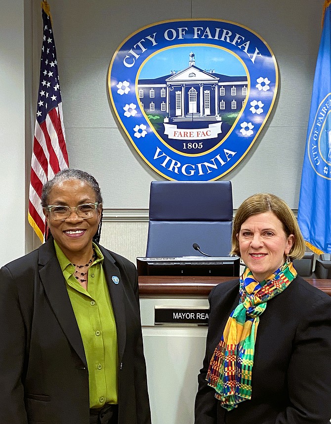 From left are Stacey Hardy-Chandler and Catherine Read under the City seal.