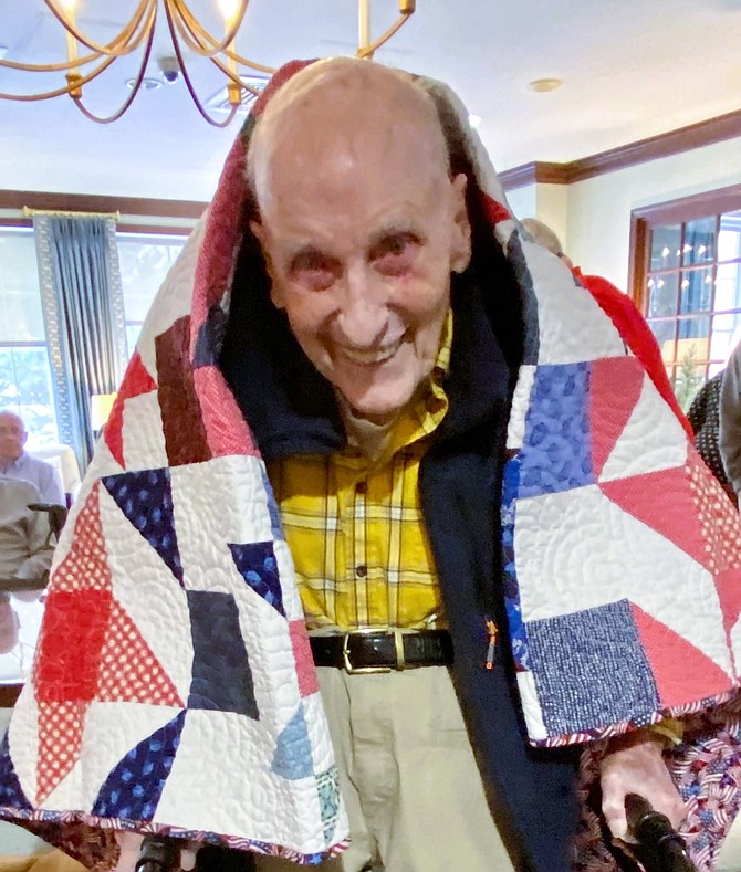 WWII Marine veteran Jim Wescoat wearing his Quilt of Valor.