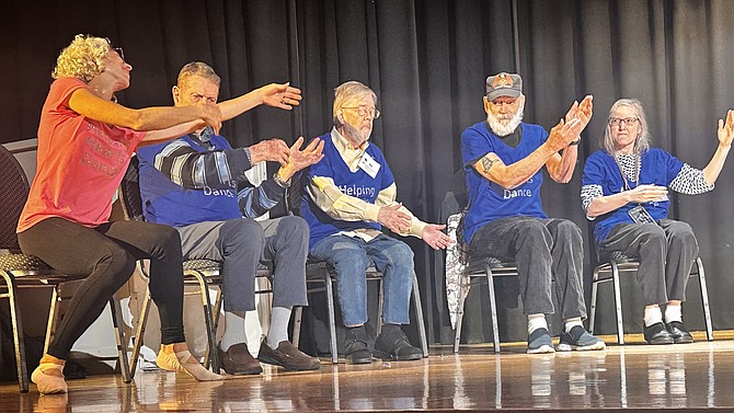 Led by their instructor, seniors perform a chair dance recital with Helping Hearts Dance Nov. 21, 2024, at the Nannie J. Lee Recreation Center.