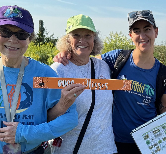 From left. Kathy Stewart, Susan Laume and Dr. Karin Lehnigk after the 2024 caterpillar count where Laume was presented with the surprise “Bugs and Hisses” sign from a group of volunteers for her years of working with the team.