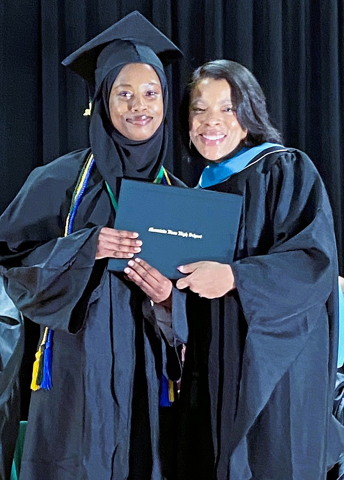 Zainab Kaira gets her diploma from Erin Whatley.