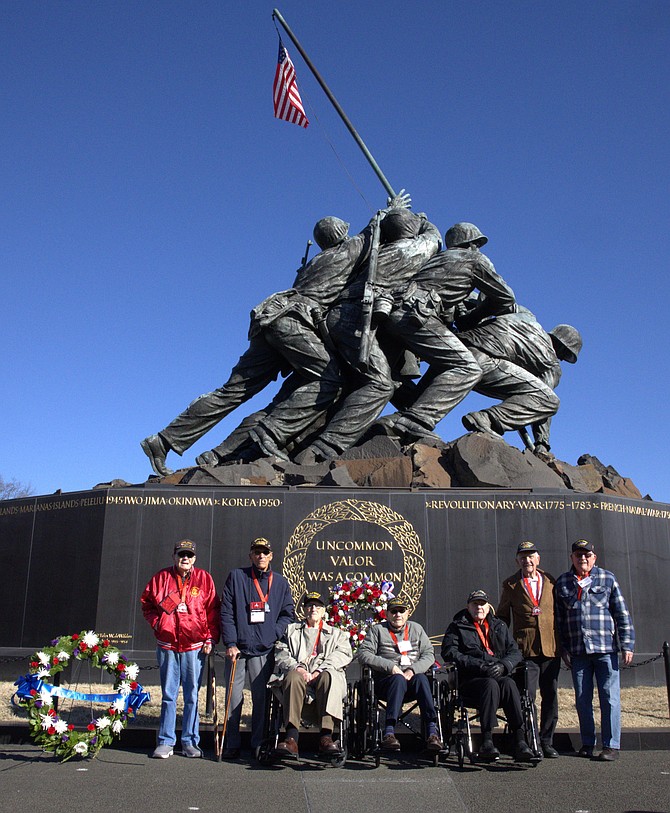 Survivors of the Battle of Iwo Jima pose for a photo following a wreath laying Feb. 21 at the Marine Corps War Memorial to mark the 80th anniversary of the battle.