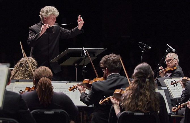 Conductor Christopher Zimmerman leads his musicians.
