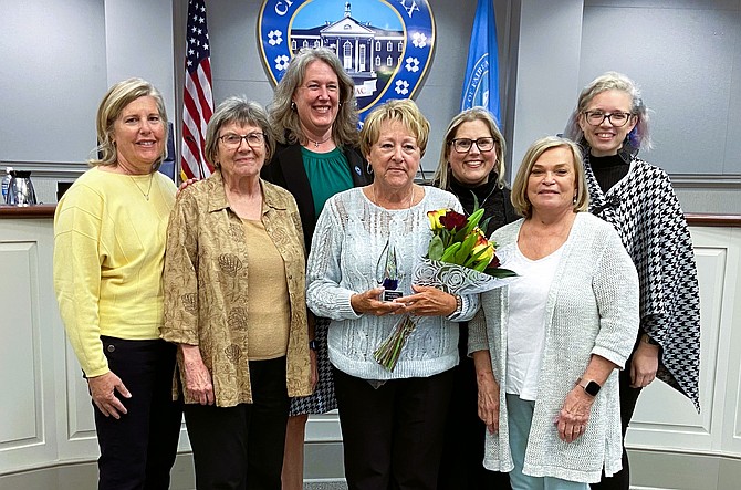 Flanking Anita Light (with flowers) are some of the past Women of Influence, (from left) Susan Barborek, Carolyn Sutterfield, Janet Jaworski, Jennifer Passey, Janice Miller and Kelly O’Brien.