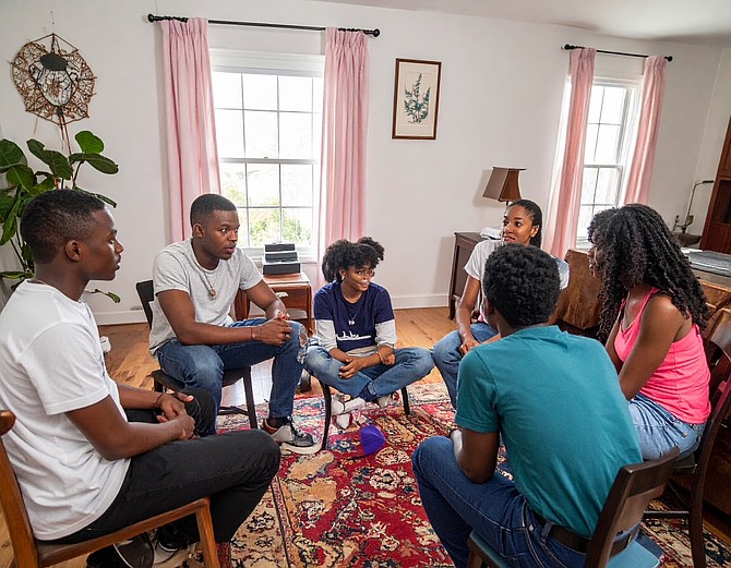 Mentors and students in The Echo Project gather in a living room for one of their weekly sessions, where conversations about literature, history, and identity foster connection and cultural empowerment.