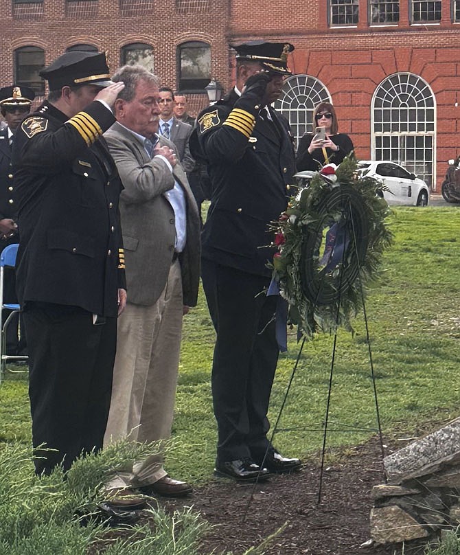 Remembering The Fallen
Sheriff Sean Casey, left, Jeremy Lenzer, president of the Retired Police, Fire and Sheriff’s Association, and Alexandria Chief of Police Tarrick McGuire pay tribute to Alexandria’s fallen after placing a wreath at the fallen officers memorial May 6 in Waterfront Park.