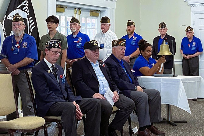 Veterans in line to read names while, seated (from left) Eric Parkhurst, Richard Formica and Dan Allmacher listen to Air Force vet Karen Cosgrove ring the bell after each one.