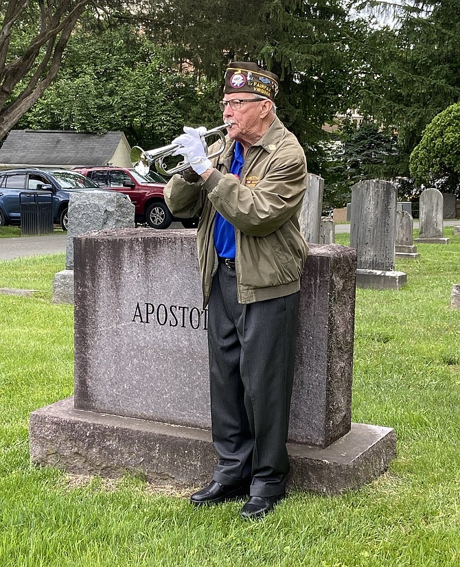 VFW’s Hank Roeder plays “Taps” in the cemetery.