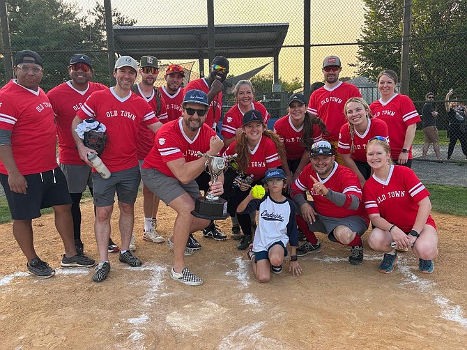 Members of the Old Town softball team pose for a photo after winning the seventh annual Old Town vs. Del Ray softball game June 2 at Eugene Simpson Field in Del Ray. Old Town took home the John Porter trophy with a 24-23 victory over Del Ray.