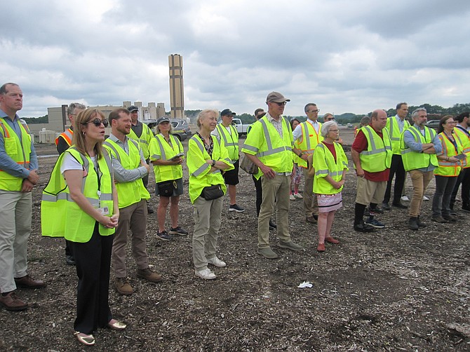 Attendees applauded the project. The Reworld waste-to-energy plant in the background processes 1.1 million tons of solid waste per year.