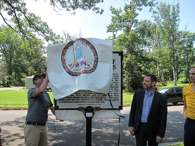 Liam Sullivan (right) uncovered the marker, as Senator Surovell and Supervisor Storck looked on.