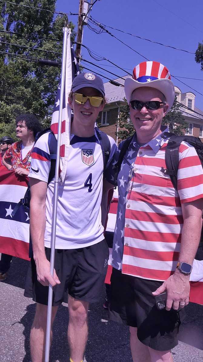 Gabe MacPhail is home from Purdue University and has been attending the Lyon Village parade since he was six-years-old. His father, Matt, is strapped with a large boom box playing patriotic music to start the annual 4th of July parade.
