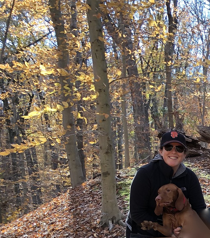 Trees encourage outdoor activities, such as dog walking in the woods for Karin Drinkhall and Callie, of Springfield