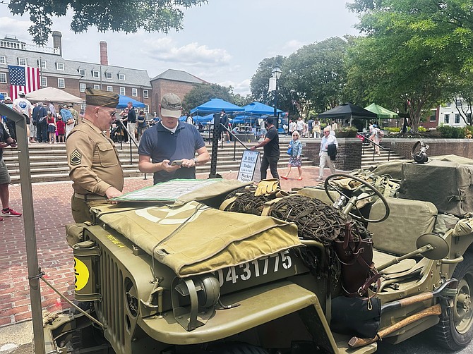 Dave Ostrander talks about his 1944 World War II Army Jeep with an attendee at the 81st D-Day commemoration June 1 at Market Square.
