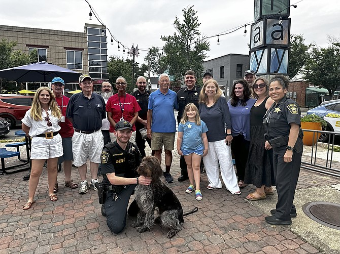 Sheriff Sean Casey, standing center, gathers with local residents Aug. 5 during National Night Out at Pat Miller Square in Del Ray.