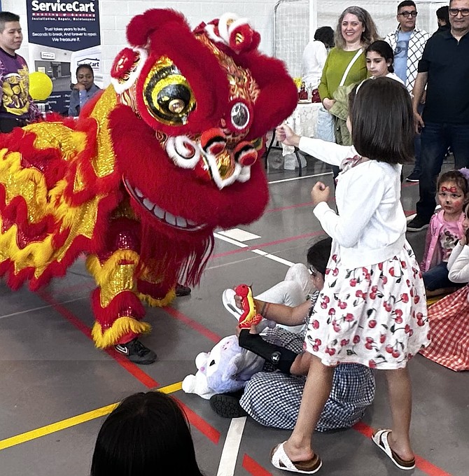 An attendee participates in the lion dance as part of the AAPI festival May 31 at Patrick Henry Recreation Center.