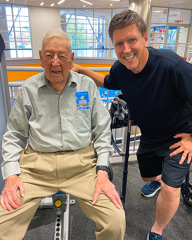 Eddie Biggar with Fairfax County Board Supervisor Walter Alcorn (Hunter Mill) at the Reston YMCA. Biggar works on the machines once or twice a week.