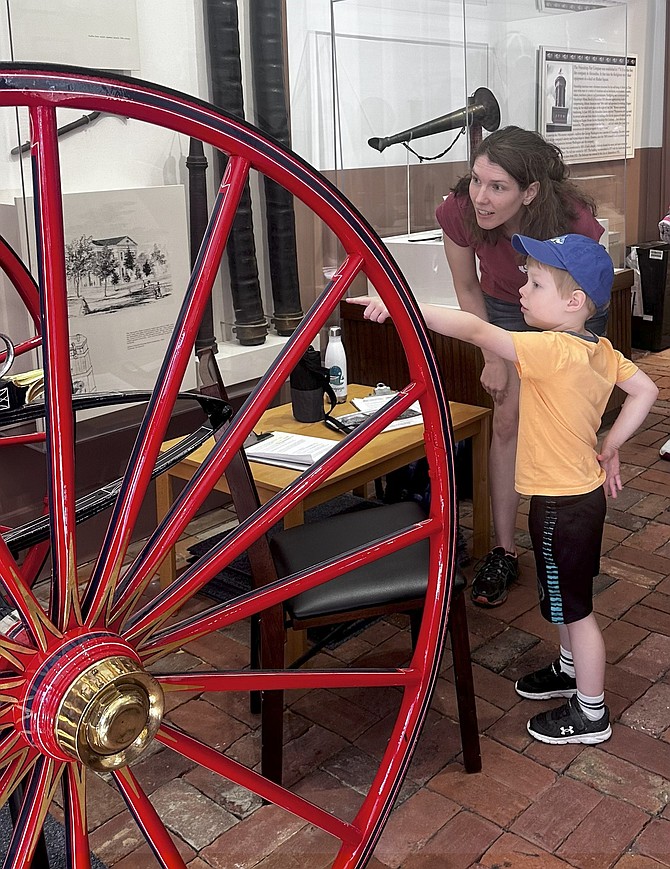 A young visitor looks at a firefighting display Aug. 2 at the Friendship Firehouse Museum.