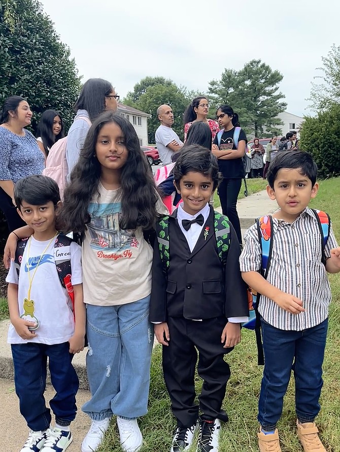 From left, Town of Herndon young residents, Muaazm, 5, Emaan, 9, Usman, 6, and Taha, 5, pose for a photo as they await the Fairfax County School bus to take them to Aldrin Elementary School in Reston.