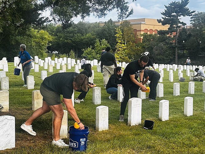 Volunteers clean headstones in Alexandria National Cemetery as part of the Sept. 11 National Day of Service. More than 4,000 headstones were cleaned in remembrance of those lost in the 9/11 terrorist attacks.